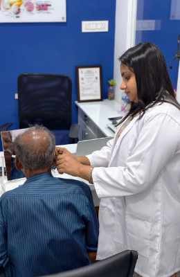 Patient trying hearing aids at the clinic